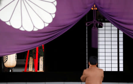 A wooden plaque (L) showing the name of Japanese Prime Minister Shinzo Abe is seen with a "masakaki" tree that Abe sent as a ritual offering for war dead at Yasukuni Shrine in Tokyo, Japan October 17, 2017. REUTERS/Kim Kyung-Hoon