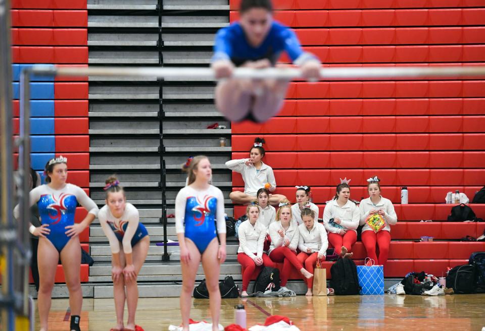Gymnasts rest between routines in the Metro Athletic Conference gymnastics meet on Saturday, January 29, 2022 at Lincoln High School in Sioux Falls.