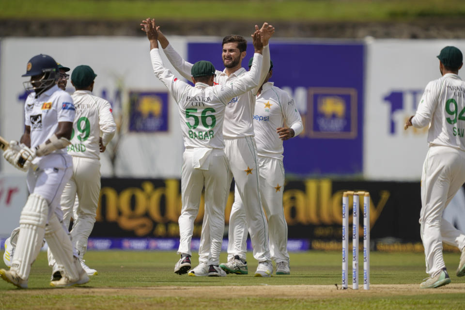 Pakistan's Shaheen Shah Afridi, without cap, celebrates taking the wicket of Sri Lanka's Nishan Madushka, left, with teammates during the day one of the first test cricket match between Sri Lanka and Pakistan in Galle, Sri Lanka on Sunday, July 16, 2023. (AP Photo/Eranga Jayawardena)