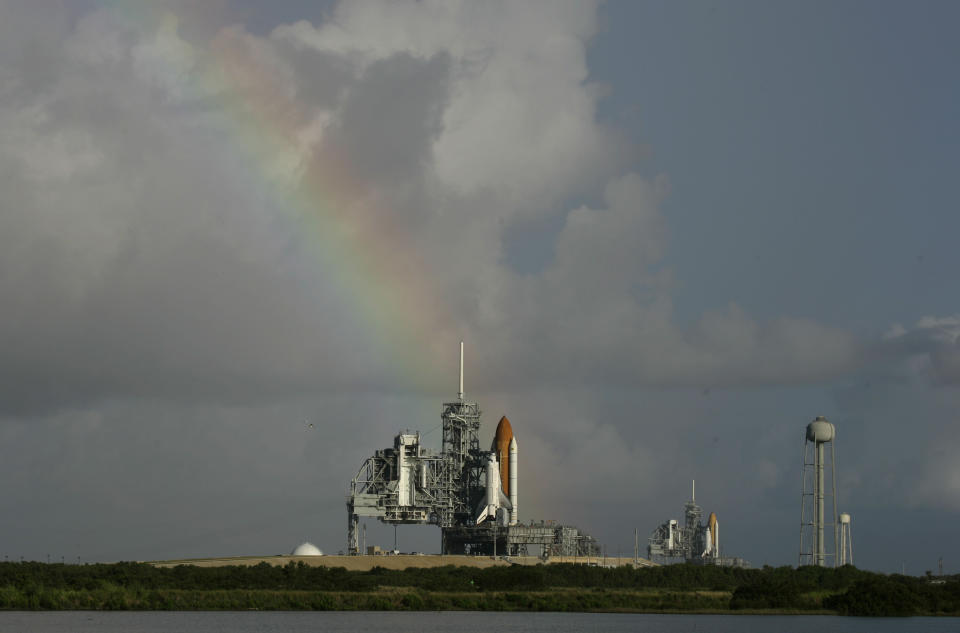 FILE - In this Saturday, Sept. 20, 2008 file photo, space shuttle Atlantis on pad 39A, left, and Endeavour on pad 39B stand ready in front of a rainbow in the early morning at Kennedy Space Center in Cape Canaveral, Fla. Dormant for nearly six years, Launch Complex 39A at NASA’s Kennedy Space Center should see its first commercial flight on Feb. 18, 2017. A SpaceX Falcon 9 rocket will use the pad to hoist supplies for the International Space Station. (AP Photo/John Raoux)