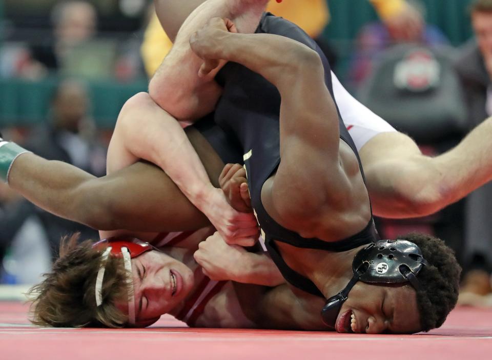 Wadsworth's Chris Earnest, left, works his way to a tilt on Perrysburg's Wynton Denkins during their 150 pound match in the Division I championship round of the OHSAA State Wrestling Tournament at the Jerome Schottenstein Center on Sunday.