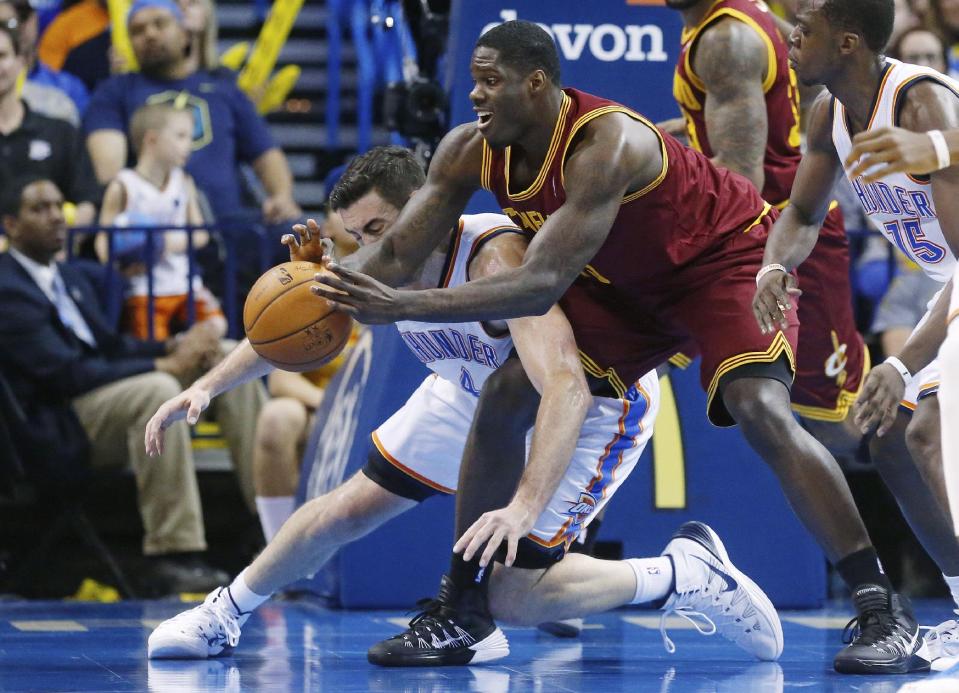 Cleveland Cavaliers forward Anthony Bennett (15) reaches for the ball in front of Oklahoma City Thunder forward Nick Collison (4) during the fourth quarter of an NBA basketball game in Oklahoma City, Wednesday, Feb. 26, 2014. Cleveland won 114-104. (AP Photo/Sue Ogrocki)