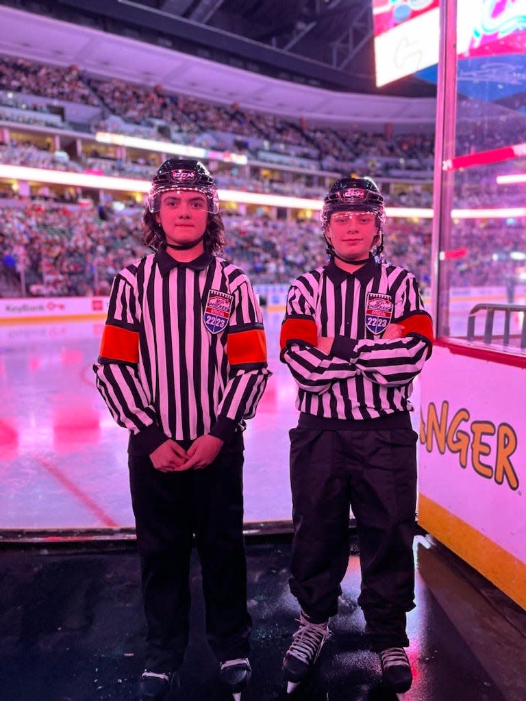 Junior referees Zeke Phillips and Hollis Cooper are pictured at the Feb. 25 Colorado Avalanche and Calgary Flames game.