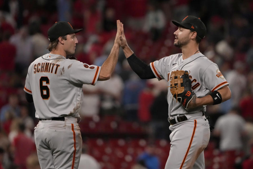 San Francisco Giants' Michael Conforto, right, and Casey Schmitt (6) celebrate a 4-3 victory over the St. Louis Cardinals following a baseball game Monday, June 12, 2023, in St. Louis. (AP Photo/Jeff Roberson)