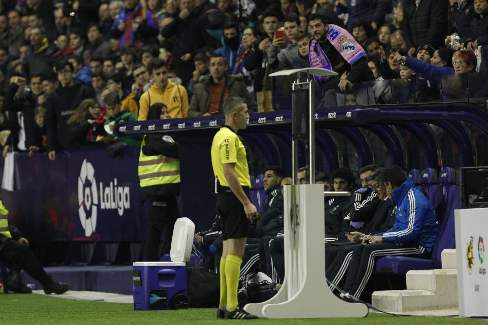 Referee Ignacio Iglesias Villanueva watches the VAR monitor and assigns the penalty for Real Madrid during a Spanish La Liga soccer match at the Ciutat de Valencia stadium in Valencia, Spain, Sunday, Feb. 24, 2019.(AP Photo/Alberto Saiz)