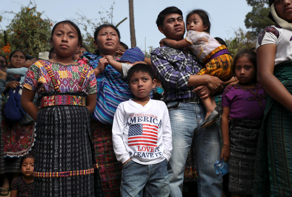 <p>Families attend a memorial service for two boys who were kidnapped and killed on Feb. 14, 2017, in San Juan Sacatepequez, Guatemala. More than 2,000 people walked in a funeral procession for Oscar Armando Top Cotzajay, 11, and Carlos Daniel Xiqin, 10, who were abducted while walking to school. Residents found the boys stuffed in sacks, with their throats slashed and hands and feet bound. Neighbors reported a ransom demand was made. Such crimes have driven emigration from Guatemala to the U.S. as families seek refuge from the violence. (Photo: John Moore/Getty Images) </p>