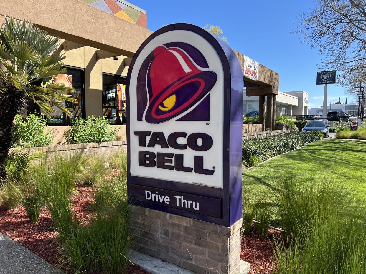 Taco Bell drive-thru open for business with lush green plants and clear sky in a residential neighborhood, Walnut Creek, California, March 27, 2023. (Photo by Smith Collection/Gado/Getty Images)