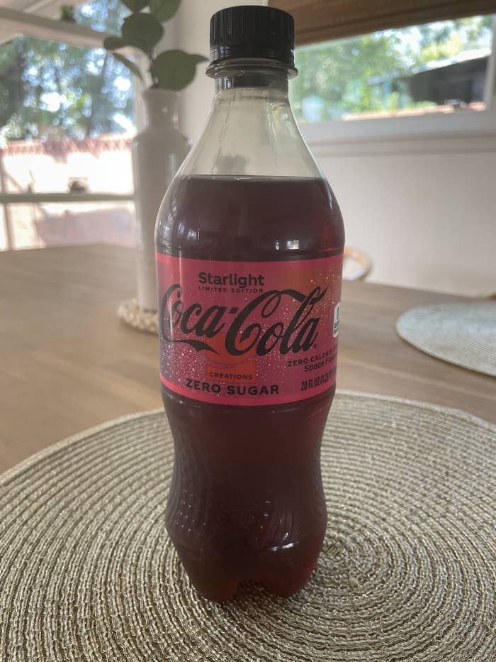 A bottle of Coke Zero Starlight sitting on a table