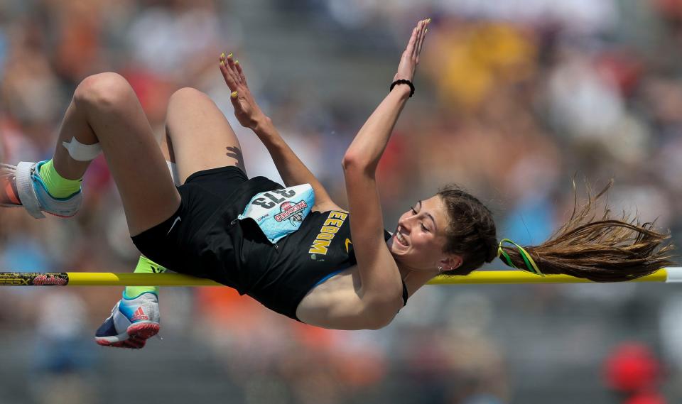 Freedom's Lydia Merrick smiles as she clears the bar during the Division 2 high jump competition during the WIAA state track and field championships Saturday in La Crosse.