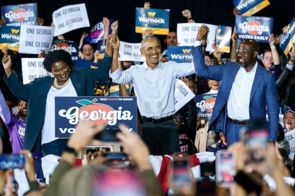 PHOTO: Former President Barack Obama raises hands with Democratic Gubernatorial candidate Stacey Abrams and Sen. Raphael Warnock at a campaign event for Georgia Democrats on Oct. 28, 2022 in College Park, Ga. (Elijah Nouvelage/Getty Images)