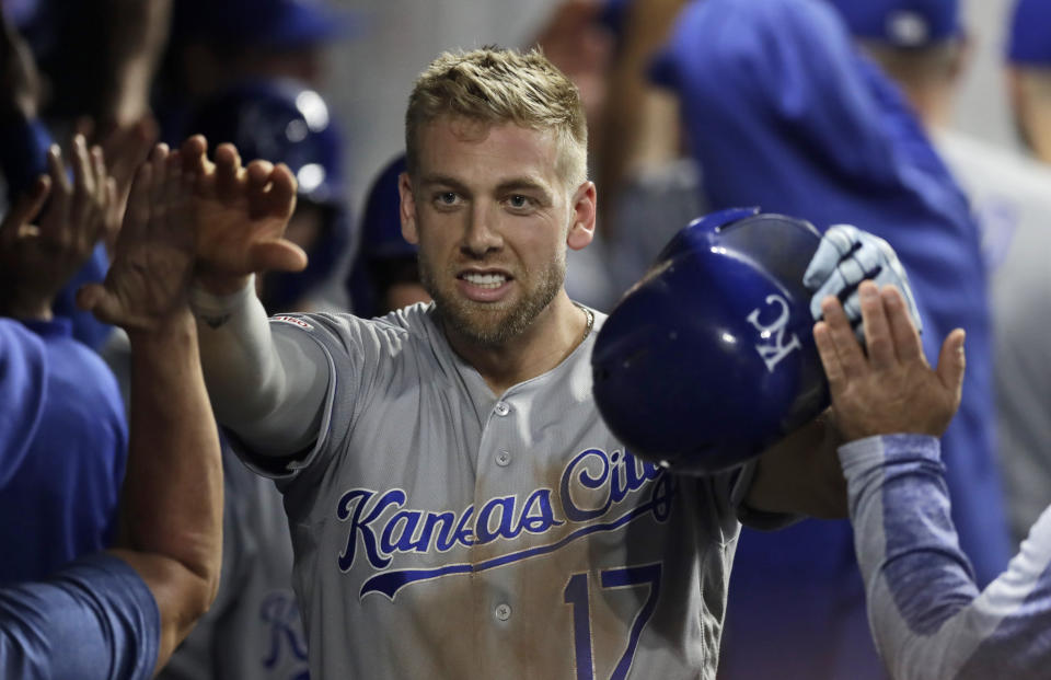Kansas City Royals' Hunter Dozier is congratulated by teammates after hitting a grand slam in the ninth inning of a baseball game against the Cleveland Indians, Tuesday, June 25, 2019, in Cleveland. (AP Photo/Tony Dejak)