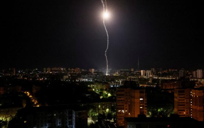 Explosion of a missile is seen in the sky over the city during a Russian missile strike - GLEB GARANICH/REUTERS