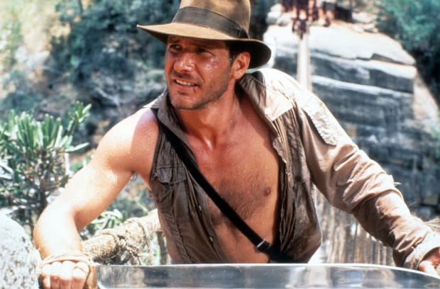 Harrison Ford as Indiana Jones in "<span class="caas-xray-inline-tooltip"><span class="caas-xray-inline caas-xray-entity caas-xray-pill rapid-nonanchor-lt" data-entity-id="Indiana_Jones_and_the_Temple_of_Doom" data-ylk="cid:Indiana_Jones_and_the_Temple_of_Doom;pos:1;elmt:wiki;sec:pill-inline-entity;elm:pill-inline-text;itc:1;cat:Movie;" tabindex="0" aria-haspopup="dialog"><a href="https://search.yahoo.com/search?p=Indiana%20Jones%20and%20the%20Temple%20of%20Doom" data-i13n="cid:Indiana_Jones_and_the_Temple_of_Doom;pos:1;elmt:wiki;sec:pill-inline-entity;elm:pill-inline-text;itc:1;cat:Movie;" tabindex="-1" data-ylk="slk:Indiana Jones and the Temple of Doom;cid:Indiana_Jones_and_the_Temple_of_Doom;pos:1;elmt:wiki;sec:pill-inline-entity;elm:pill-inline-text;itc:1;cat:Movie;" class="link ">Indiana Jones and the Temple of Doom</a></span></span>"<p><a href="https://www.gettyimages.com/detail/news-photo/harrison-ford-in-a-scene-from-the-film-indiana-jones-and-news-photo/168583215" rel="nofollow noopener" target="_blank" data-ylk="slk:Paramount/Getty Images;elm:context_link;itc:0;sec:content-canvas" class="link ">Paramount/Getty Images</a></p>