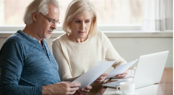 A retired couple looks over their retirement portfolio. T. Rowe Price studied alternative withdrawal strategies suited for retirees with a primary focus on meeting their spending needs, as well as those with considerable assets and a desire to leave an estate for their heirs.