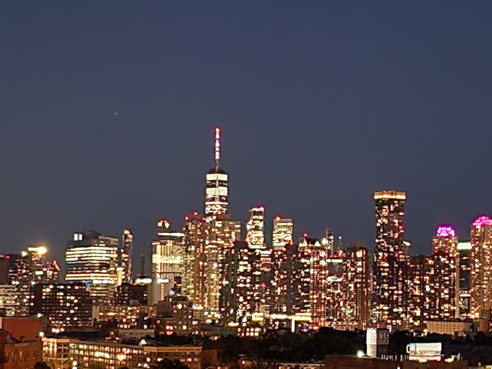 <p>A picture taken with the Galaxy Z Flip 4 showing a closeup of Manhattan buildings at night, taken from afar and zoomed in.</p>
