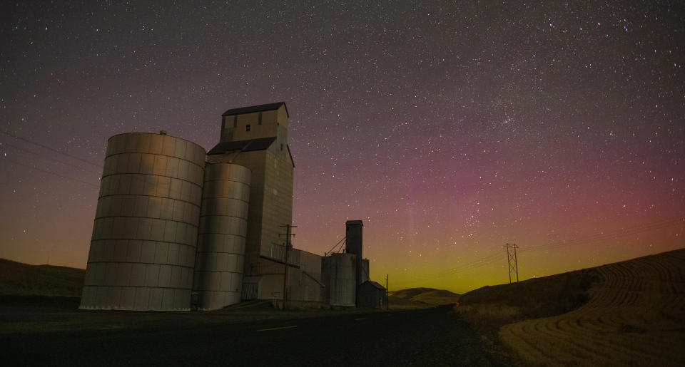 The Northern Lights glow faintly beyond a group of elevators along Sudbury Road northwest of Walla Walla, Washington, late Thursday night, July 13, 2023. Barely visible to the naked eye, this image required an exposure of several seconds to bring out the hues.  / Credit: Greg Lehman Walla Walla Union-Bulletin / AP