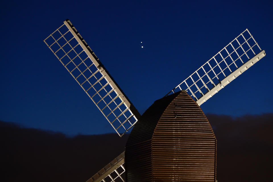 Jupiter and Saturn are seen coming together in the night sky, over the sails of Brill windmill, on December 20, 2020, in Brill, England.  / Credit: Jim Dyson/Getty Images