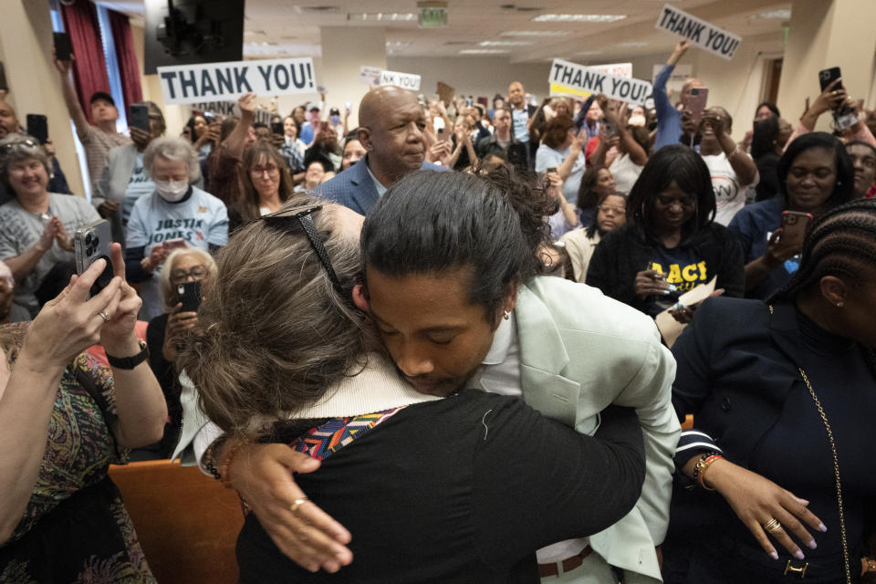 State Rep. Justin Jones, D-Nashville, hugs Ingrid McIntyre in the Metro Nashville City Council Chamber after he was reinstated to represent District 52 during a special meeting Monday, April 10, 2023, in Nashville, Tenn. Jones, who was expelled last week from the GOP-led Tennessee House over his role in a gun-control protest on the House floor, was reinstated Monday after Nashville’s governing council voted to send him straight back to the Legislature. (AP Photo/George Walker IV)