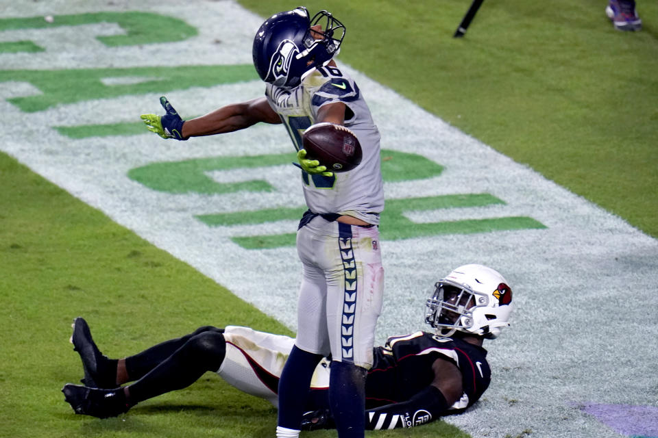 Seattle Seahawks wide receiver Tyler Lockett (16) celebrates his touchdown as Arizona Cardinals cornerback Patrick Peterson looks up during the first half of an NFL football game, Sunday, Oct. 25, 2020, in Glendale, Ariz. (AP Photo/Ross D. Franklin)