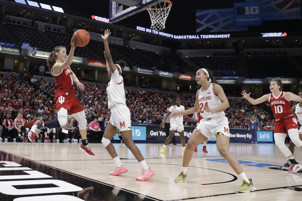 Indiana's Ali Patberg (14) makes a pass against Maryland's Kaila Charles (5) during the second half of an NCAA college basketball semifinal game at the Big Ten Conference tournament, Saturday, March 7, 2020, in Indianapolis. Maryland won 66-51. (AP Photo/Darron Cummings)