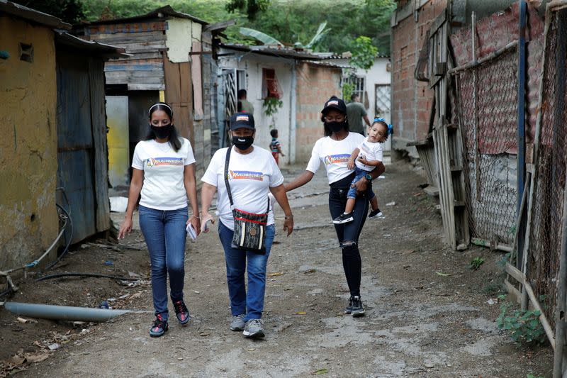 Members of the party Avanzada Progresista walk during a campaign evet at the low income neighborhood of Marapa in La Guaira
