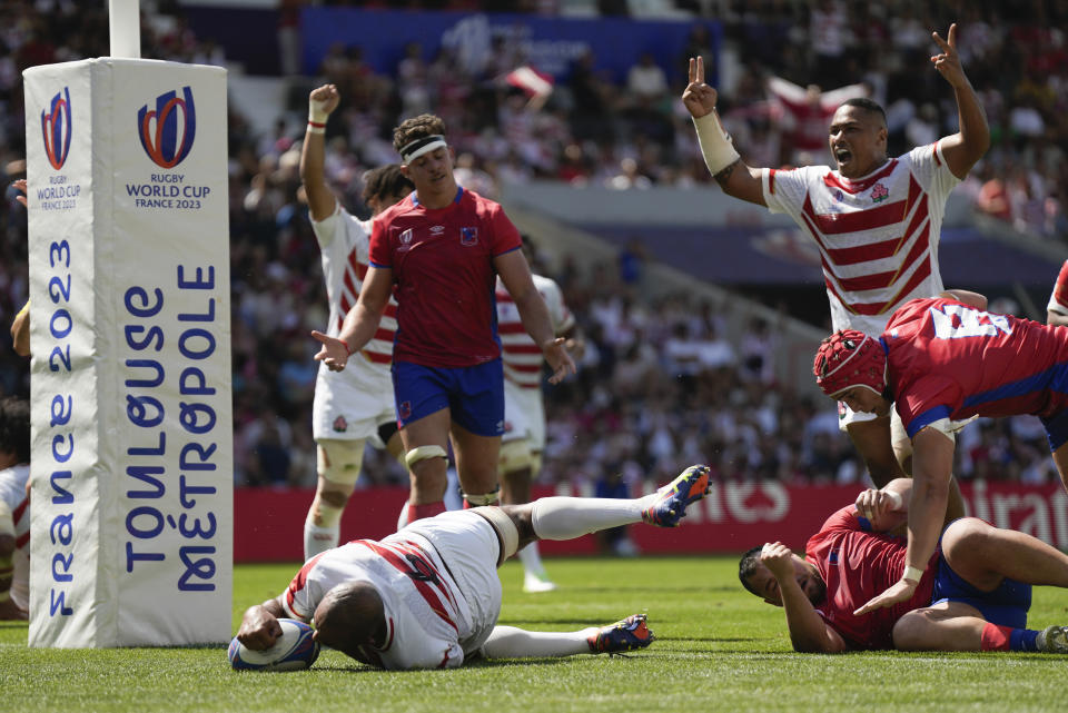 Japan's Michael Leitch scores his team's fourth try as teammates react during the Rugby World Cup Pool D match between Japan and Chile at Stadium de Toulouse, Toulouse, France, Sunday, Sept. 10, 2023. (AP Photo/Lewis Joly)