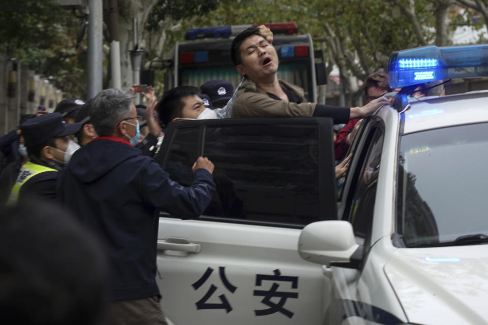 FILE - A protester resist as he is taken away by policemen from a street in Shanghai, China on Nov. 27, 2022. Thousands of people demonstrated across China in what came to be called the White Paper movement, after the blank sheets of paper protesters used to represent the country's strict censorship controls. One year later, China has all but forgotten the protests. The state reacted quickly, breaking up the marches with arrests and threats and ending COVID-19 controls. (AP Photo, File)