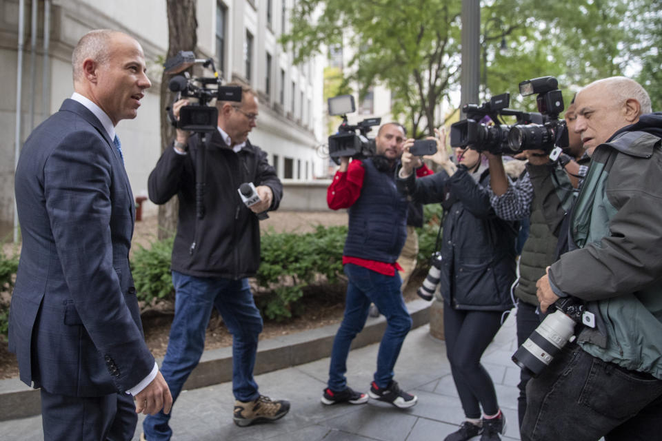 Attorney Michael Avenatti, left, is surrounded by photographers as he leaves Manhattan Federal court, Tuesday, Oct. 8, 2019, in New York. (AP Photo/Mary Altaffer)