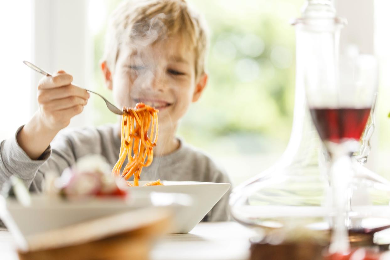 Child eating spaghetti.