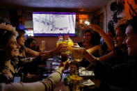 Guests toast during a viewing party of the British Royal wedding of Prince Harry and Meghan Markle, at the Churchill Tavern in New York City, U.S., May 19, 2018. REUTERS/Brendan McDermid