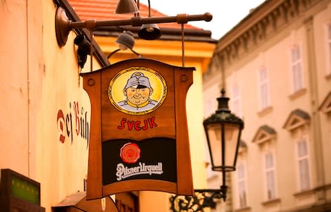 A sign advertising Pilsner Urquell - Credit: Getty