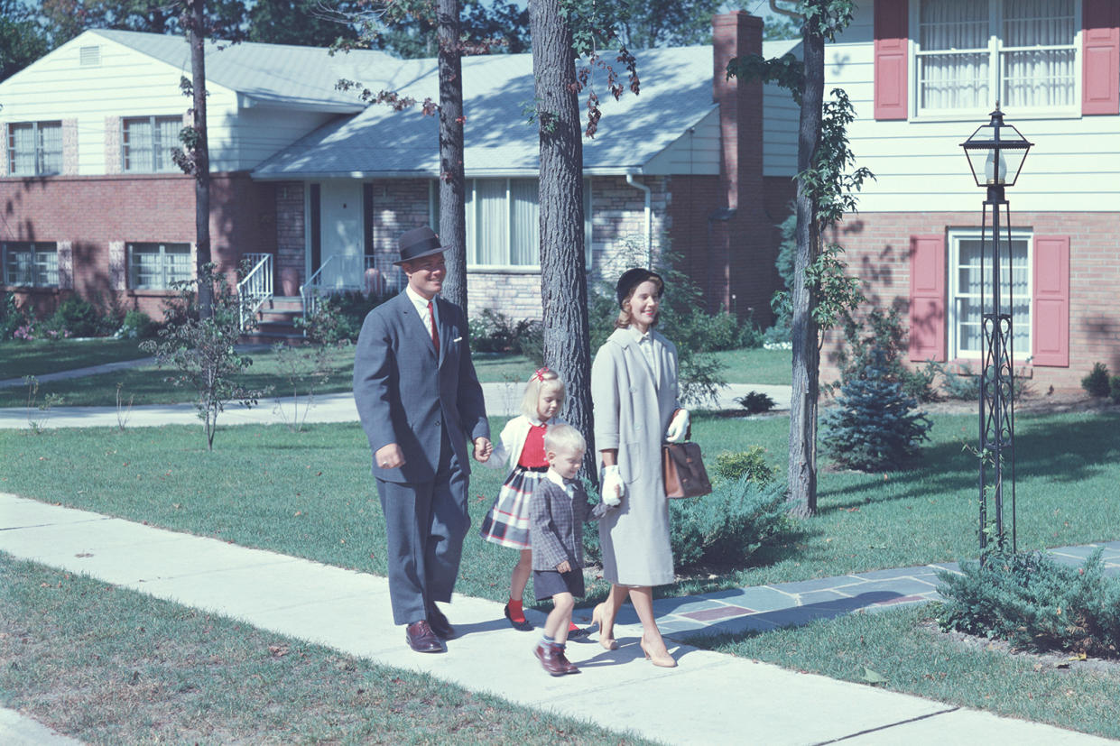 1950s family walking along a sidewalk