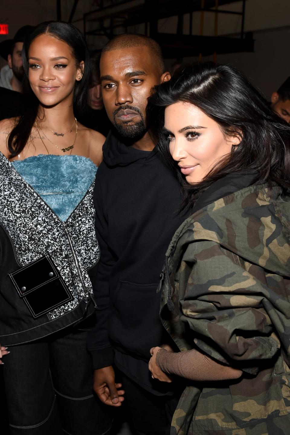 Going camo: Kim Kardashian strikes her best pose as she takes a picture with husband Kanye West and Rihanna (Picture: Dimitrios Kambouris/Getty Images for adidas) (Dimitrios Kambouris/Getty Images )