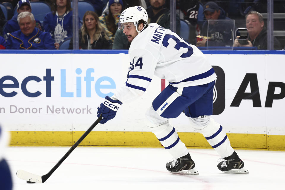 Toronto Maple Leafs center Auston Matthews (34) carries the puck up ice during the first period of an NHL hockey game against the Buffalo Sabres, Saturday, March 30, 2024, in Buffalo, N.Y. (AP Photo/Jeffrey T. Barnes)