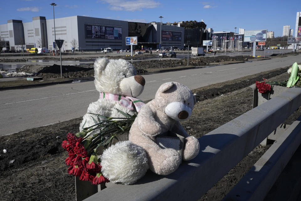 Toys and flowers lie in front of the Crocus City Hall on the western outskirts of Moscow, Russia, Wednesday, March 27, 2024. Russian officials persisted Tuesday in saying Ukraine and the West had a role in last week's deadly Moscow concert hall attack despite vehement denials of involvement by Kyiv and a claim of responsibility by an affiliate of the Islamic State group. (AP Photo/Alexander Zemlianichenko)