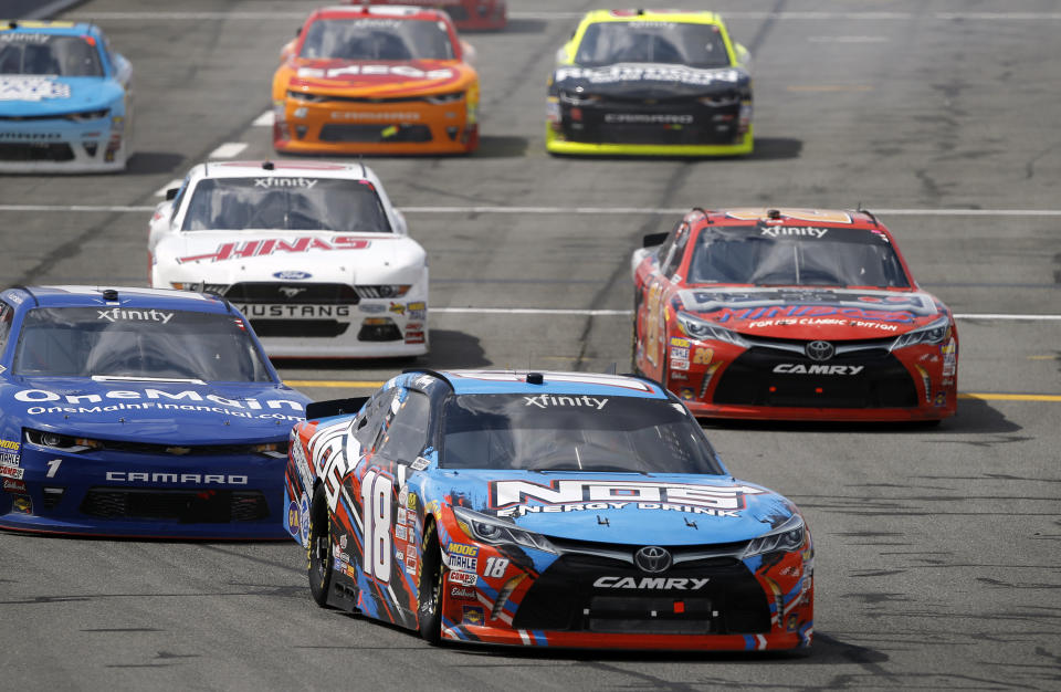 Kyle Busch (18) takes the lead after a yellow caution flag is lifted during the NASCAR Xfinity auto race at Auto Club Speedway in Fontana, Calif., Saturday, March 25, 2017. (AP Photo/Alex Gallardo)