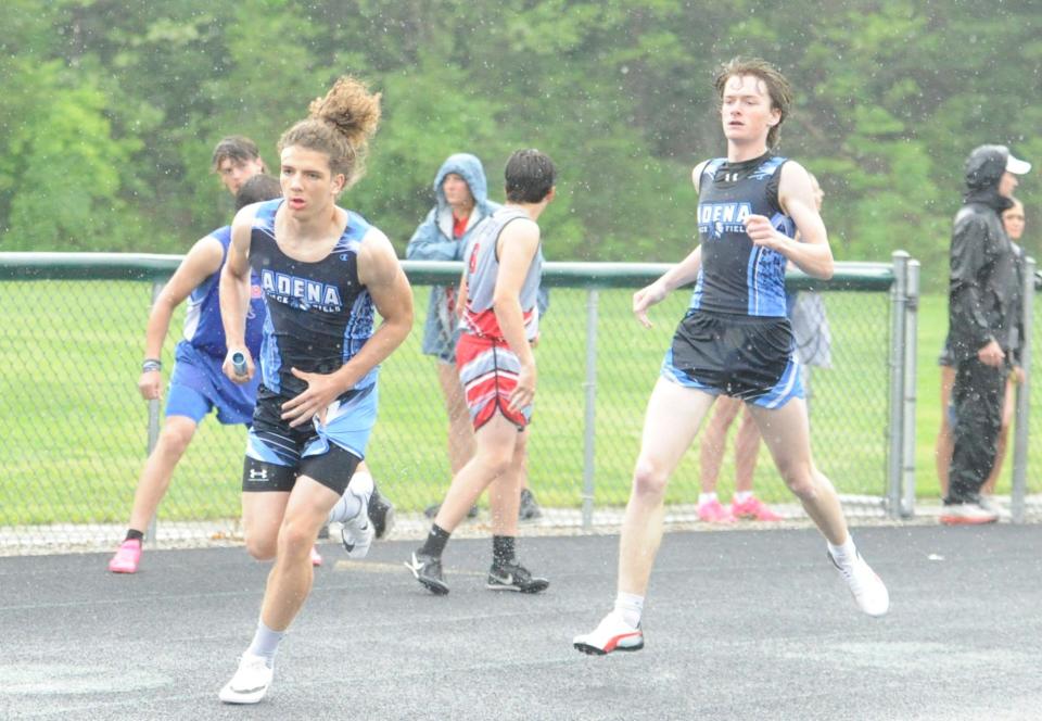Adena's Liam Ray (right) hands the baton off to teammate Darius Wagner (left) for the final leg of the boys 4x200 relay during the Scioto Valley Conference track and field championships at Huntington High School on May 12, 2023.