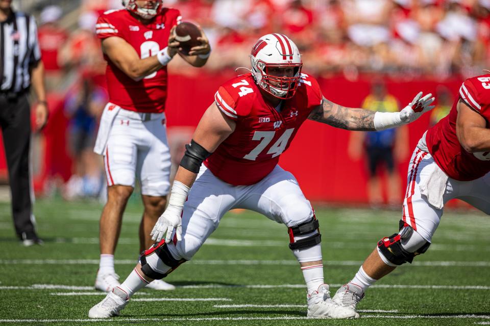 Milan graduate Michael Furtney (74) in pass protection for Wisconsin on Sept. 2 2023 in Madison, Wis.
