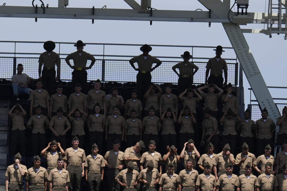 Marine recruits look on below their instructors as the San Diego Padres host the Milwaukee Brewers in a baseball game Sunday, June 23, 2024, in San Diego. (AP Photo/Gregory Bull)
