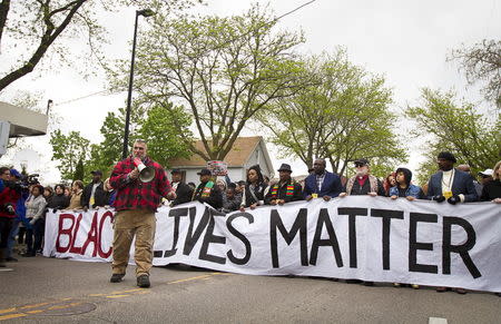 Craig Spaulding speaks to the crowd before marching after a prosecutor said that a police officer will not face charges in the fatal shooting of an unarmed 19-year-old biracial man, in Madison, Wisconsin May 12, 2015. REUTERS/Ben Brewer