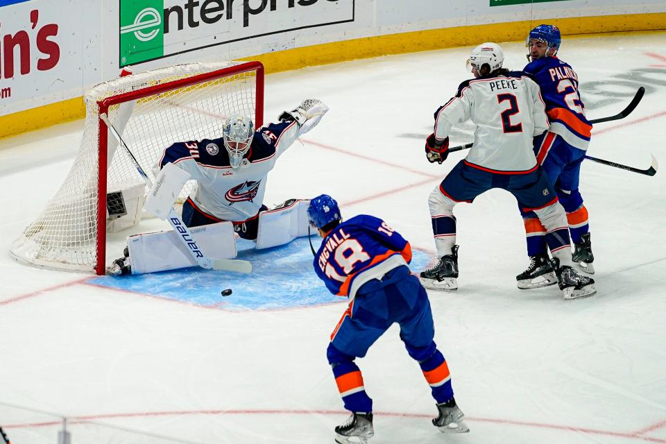 New York Islanders left wing Pierre Engvall (18) shoots against Columbus Blue Jackets goaltender Spencer Martin (30) during the first period of an NHL hockey game in Elmont, N.Y., Thursday, Dec. 7, 2023. (AP Photo/Peter K. Afriyie)