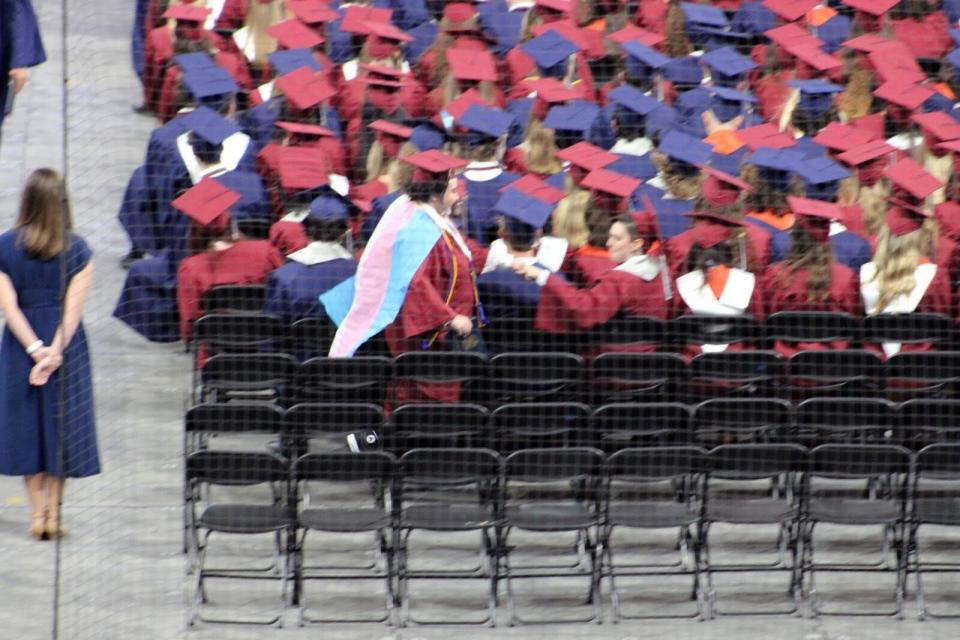 Rain Weinstein, 17, wore a transgender pride flag in protest of the so-called "Don't Say Gay" bill during his school's graduation.