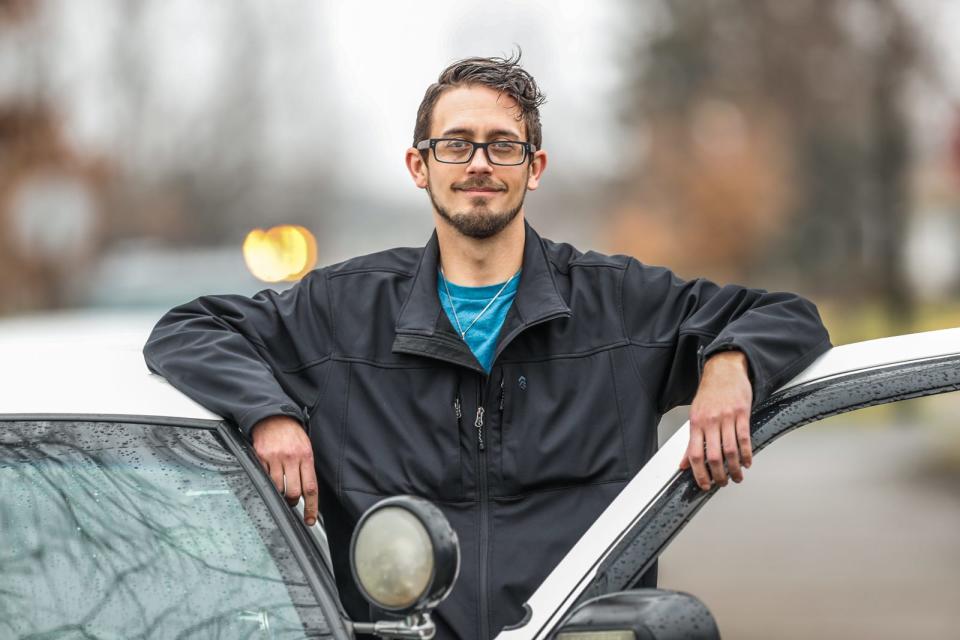 Daniel Higgs, who once suffered from homelessness and addiction issues is now giving back to that community using a former police car on Thursday, Dec. 30, 2021, on the south side of Indianapolis. Higgs drives the car in hopes of scaring away trouble while doing outreach and in the neighborhood. 