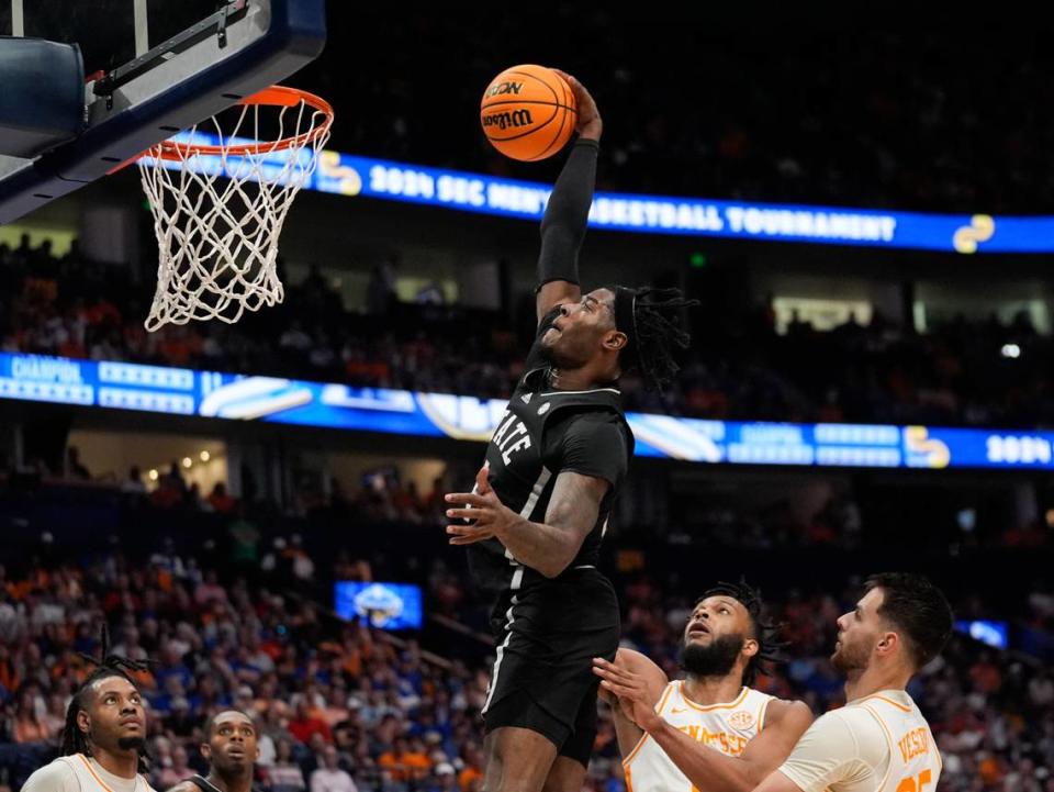 Mississippi State forward Cameron Matthews (4) scores as Tennessee guards Josiah-Jordan James (30) and Santiago Vescovi (25) defend Friday during the Bulldogs’ win at the Southeastern Conference tournament.