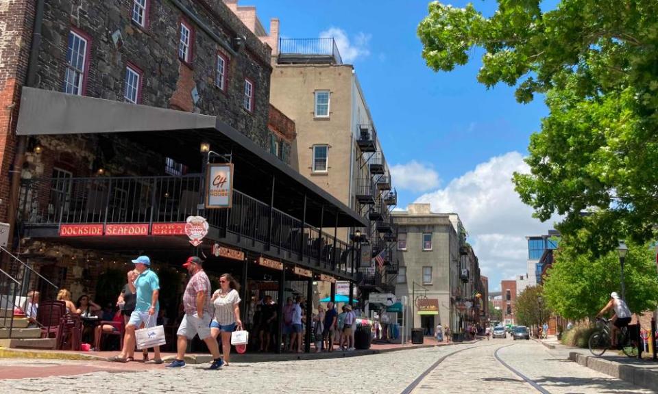 Tourists shop at the River Street shops in Savannah.