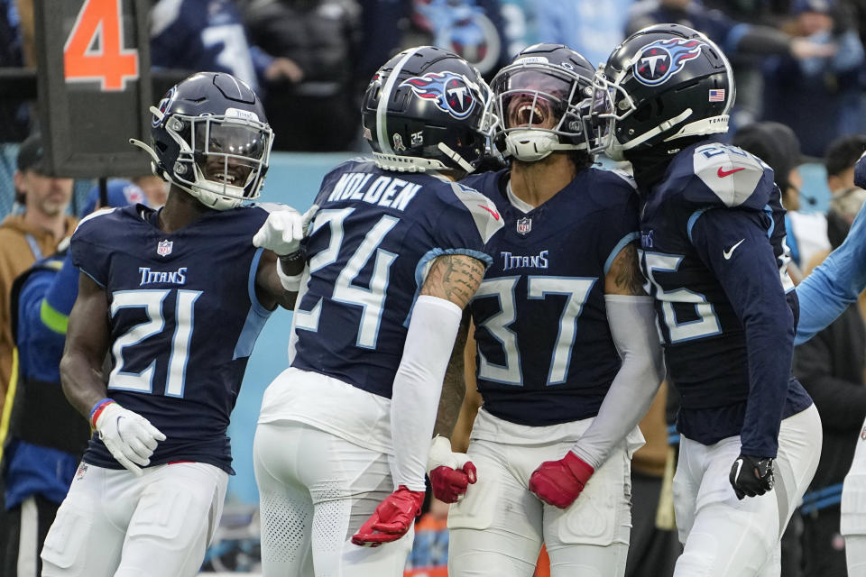 Tennessee Titans safety Amani Hooker (37) celebrates with cornerback Elijah Molden (24) after making a stop against the Carolina Panthers on a fourth down play during the Panthers' final drive of the game in the fourth quarter of an NFL football game Sunday, Nov. 26, 2023, in Nashville, Tenn. (AP Photo/George Walker IV)