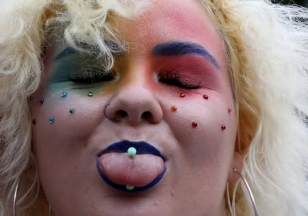 A participant poses for a picture at the canals during the annual gay pride parade in Amsterdam