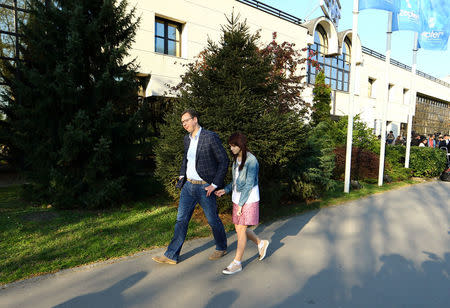 Serbian Prime Minister and presidential candidate Aleksandar Vucic walks with his daughter Milica Vucic after voting in the presidential election in Belgrade, Serbia, April 2, 2017. REUTERS/Antonio Bronic