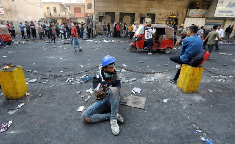 A demonstrator rests as he take part during the ongoing anti-government protests in Baghdad