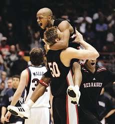 Texas Tech guard Ronald Ross jumps into the arms of teammate Joey Hawkins (50) after the No. 6 seed Red Raiders knocked off No. 3 seed Gonzaga in the second round of the 2005 NCAA Tournament. Tech won 71-69 in Tucson, Arizona.